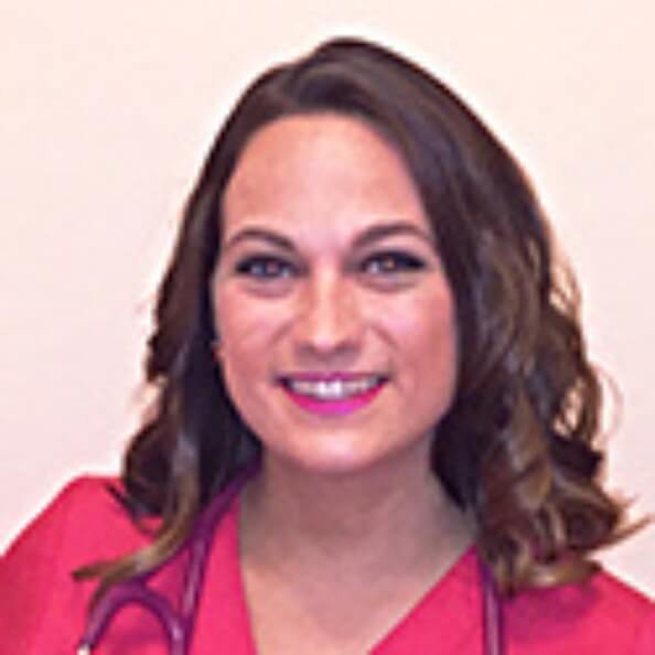 Emily Baldwin smiles in front of a white background with a stethoscope around her neck.